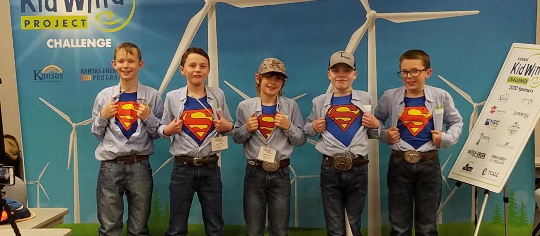 Five young students with Superman t-shirts underneath their dress shirts.