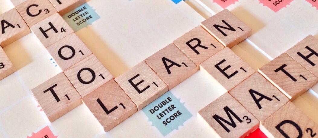 Scrabble board with words "school," "learn," and "read"