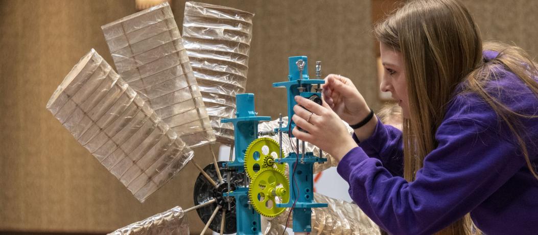 Student fixing wind turbine