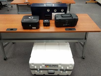 Three storage containers of different sizes and blue lightbox (used to test efficiency of three lightbulbs)