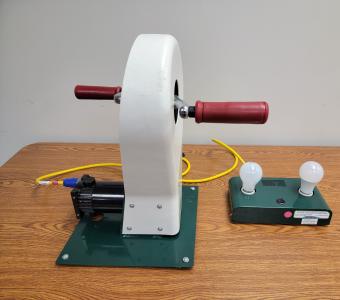 hand crank and 2 light bulbs on table